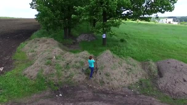 girl practicing shooting at targets - Materiał filmowy, wideo