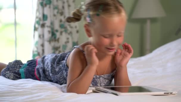 little cute girl plays a game on the tablet - Footage, Video