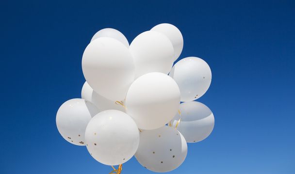 close up of white helium balloons in blue sky - Foto, immagini