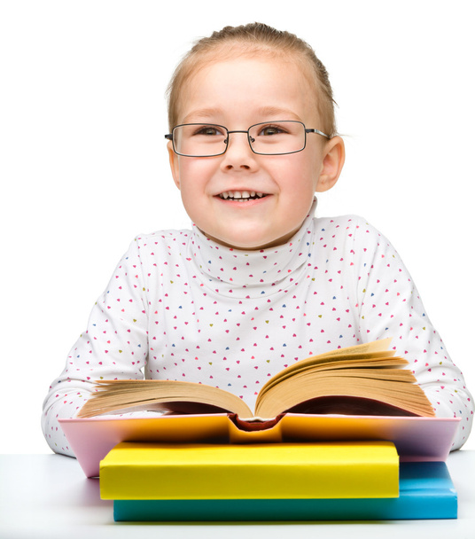 Cute cheerful little girl reading book - Photo, Image
