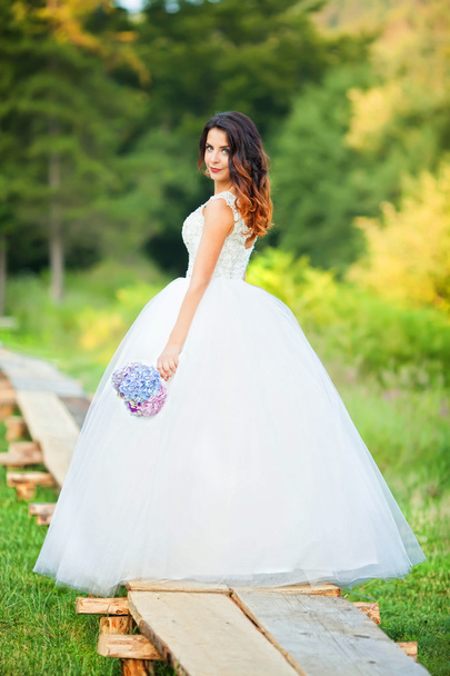 Beautiful bride in wedding dress and bridal bouquet, happy newly - Photo, Image