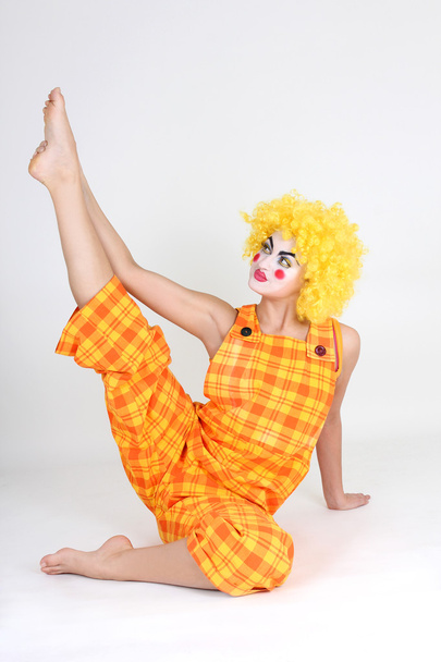 Clown in colourful costume doing gymnastic - Photo, image