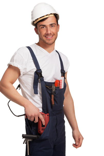 Portrait of happy young handyman with tool - Foto, Imagen