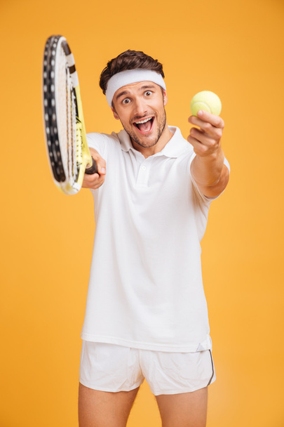 Happy young man tennis player inviting you to play - Fotó, kép