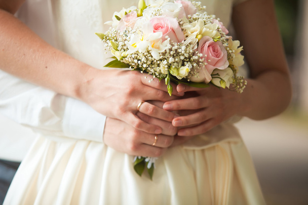 groom and bride holding wedding bouquet - 写真・画像
