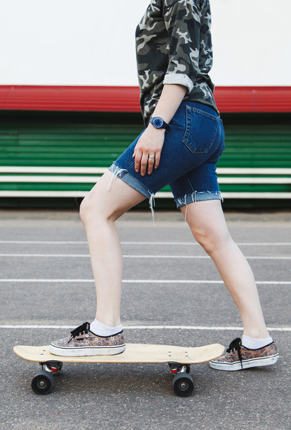 Sexy hipster girl rides longboard  - Zdjęcie, obraz