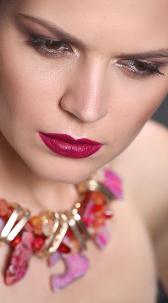 Portrait of young beautiful brunette woman in beads - Fotoğraf, Görsel
