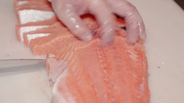 Close up shot the cook cut fresh red fish - Filmati, video