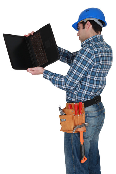 Craftsman examining his laptop - Foto, Imagem