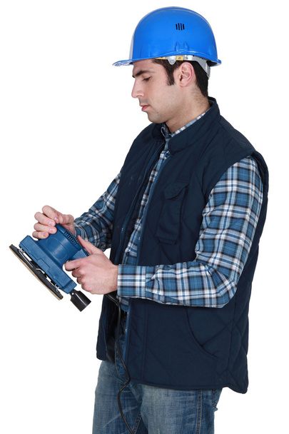 Man about to use electric sander - Photo, image