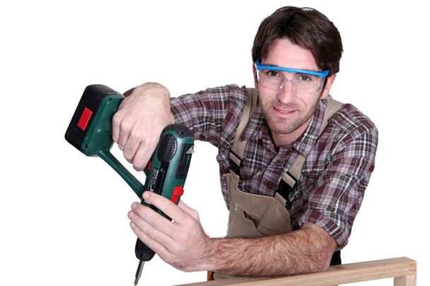 Craftsman holding a drill - Фото, зображення
