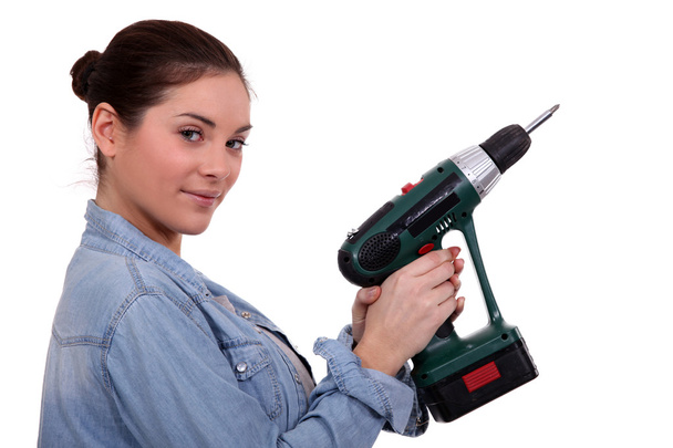 Woman holding drill on white background - Foto, Bild