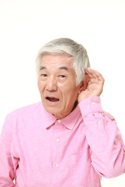 senior Japanese man with hand behind ear listening closely - Foto, Imagen