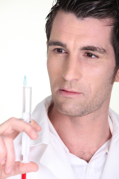 Man holding an injection - Foto, Imagem