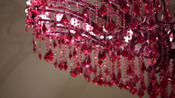 Hanging suspended crystal glass spheres lit up by red light in a dark interior at night - Footage, Video