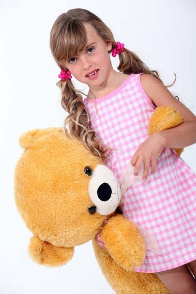 Girl with a stuffed toy - Foto, afbeelding