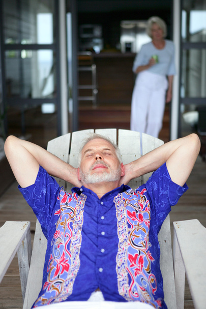 Senior man relaxing on a veranda - Фото, изображение