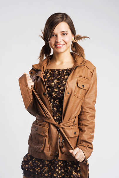 Cute young woman wearing leather jacket - Фото, зображення