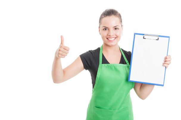 Pretty female employee with clipboard thumb up - Photo, Image