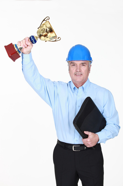 een architect houden een cup trofee. - Foto, afbeelding