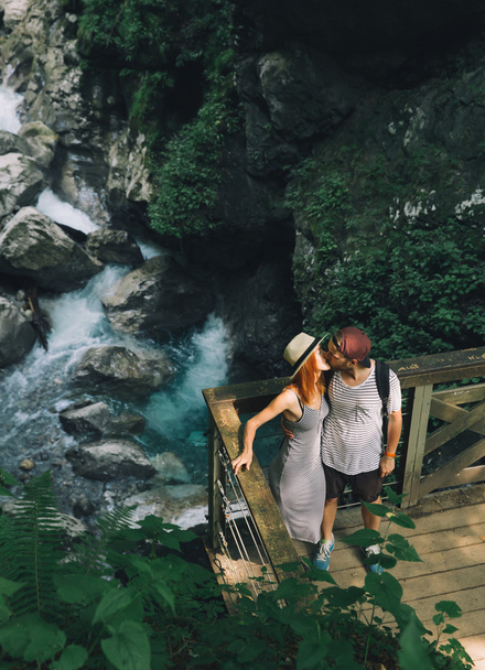 Hipster couple hiking on the background of a mountain river - Photo, Image
