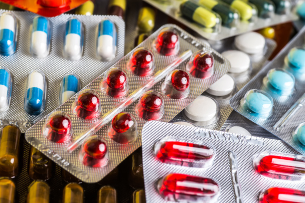 Medicine green and yellow pills or capsules. Antibiotic closeup. - Фото, зображення