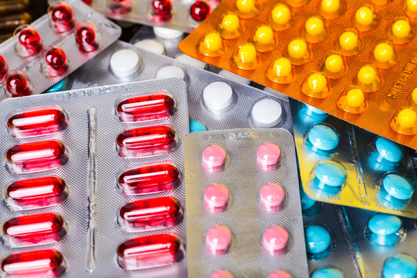 Medicine green and yellow pills or capsules. Antibiotic closeup. - Photo, Image