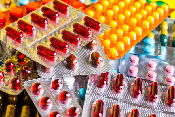 Medicine green and yellow pills or capsules. Antibiotic closeup. - Фото, изображение