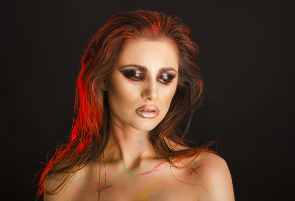 Tanned red-haired girl with interesting make up  - 写真・画像