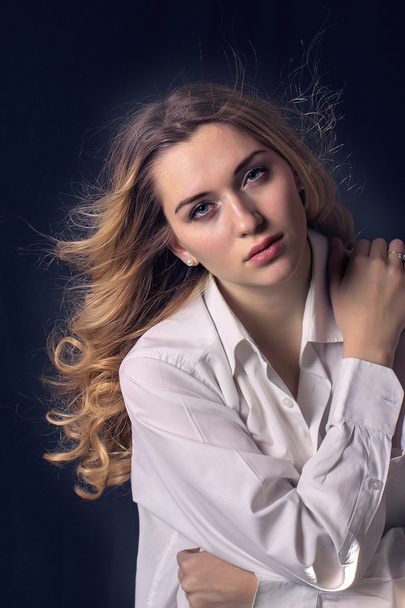 Modern stylish young woman model standing on a dark background - Фото, зображення
