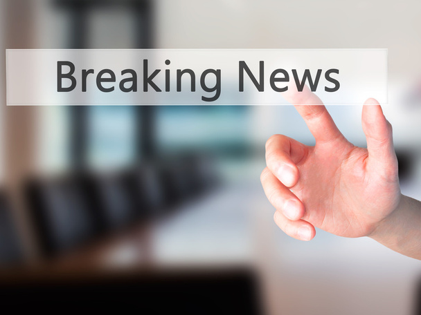 Breaking News - Hand pressing a button on blurred background con - Photo, Image