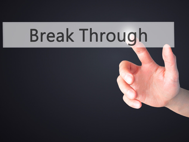 Break Through - Mano presionando un botón sobre fondo borroso con
 - Foto, Imagen