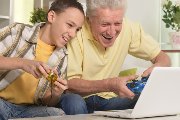 boy and  grandfather playing computer game - Foto, imagen
