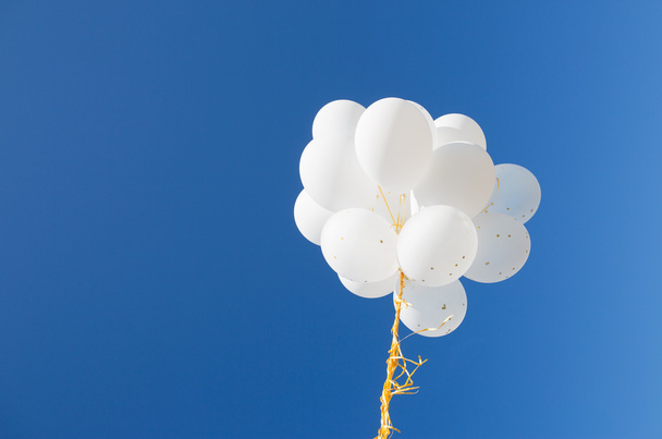 close up of white helium balloons in blue sky - Φωτογραφία, εικόνα