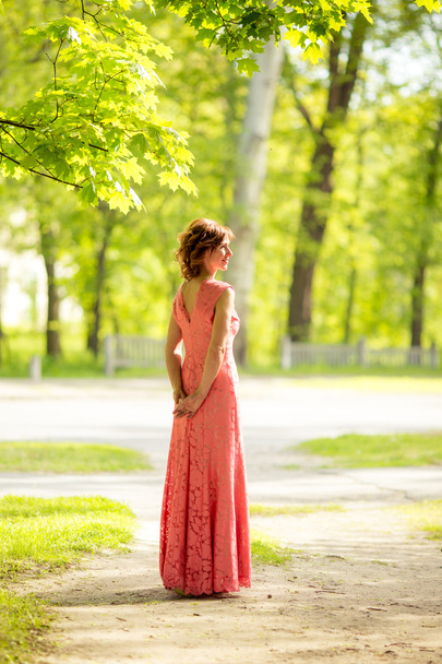 woman with makeup in long pink dress  - Photo, Image