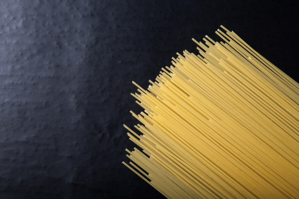 Pasta spaghetti on a black background. Space for text - Zdjęcie, obraz