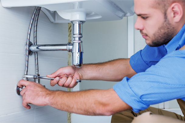Professional plumber fixing pipes - Foto, afbeelding