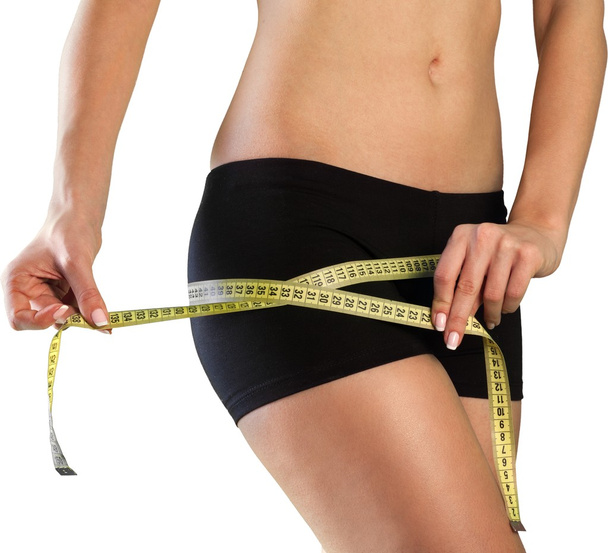 young woman measuring her thin waist  - Fotó, kép