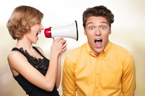 Angry young couple with megaphone - Fotoğraf, Görsel