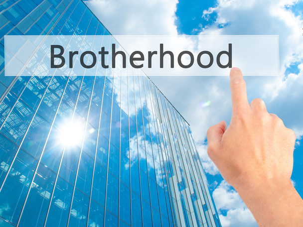 Bruderschaft - Hand drückt einen Knopf auf verschwommenem Hintergrund - Foto, Bild