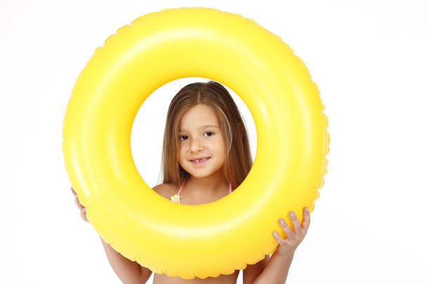 Little girl with a rubber ring - Foto, afbeelding