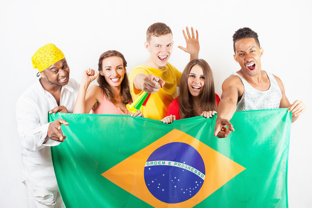 Group of multiracial people holding a Brazil flag - Photo, image