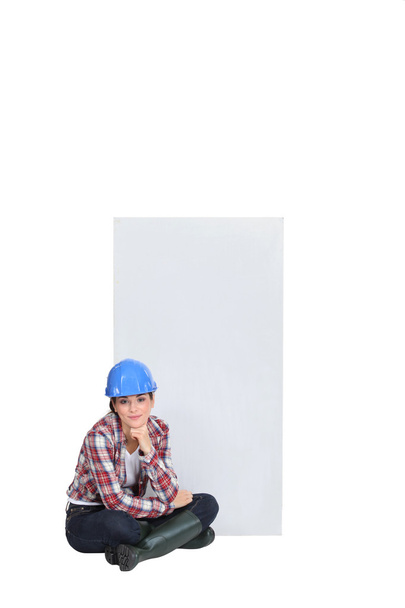Female construction worker sat on the floor thinking - Foto, Imagen