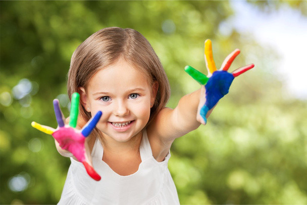 Little girl with colorful painted hands - Fotó, kép