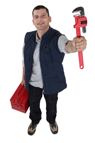 A manual worker holding a wrench. - Zdjęcie, obraz