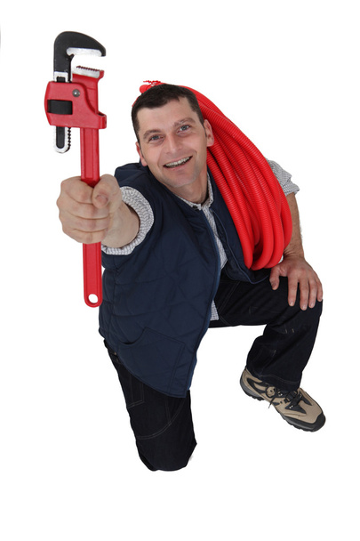 Tradesman holding up a pipe wrench - Zdjęcie, obraz