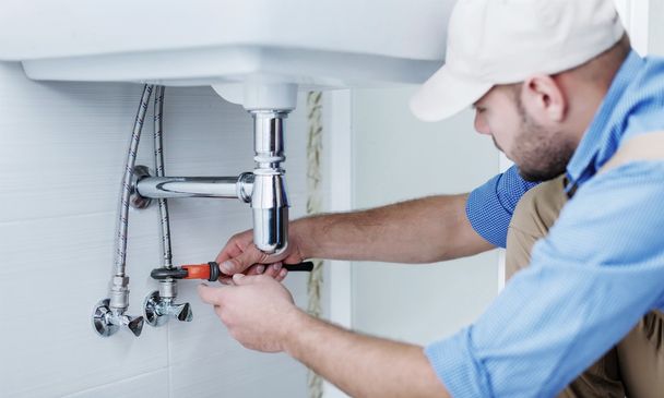 Plumber hands fixing water tap - Foto, afbeelding