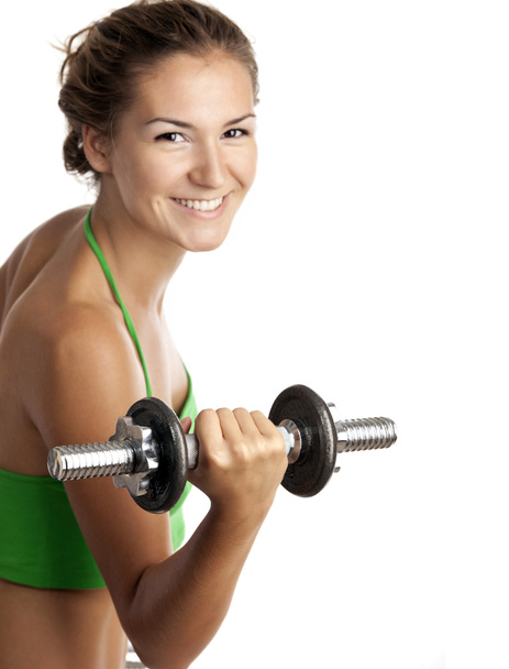 Linda chica de fitness haciendo ejercicio con pesas sobre fondo blanco
 - Foto, Imagen