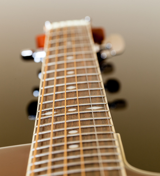 View down the fretboard of guitar - 写真・画像