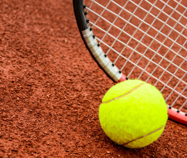 Tennis ball and racquet on a tennis clay court - Foto, imagen